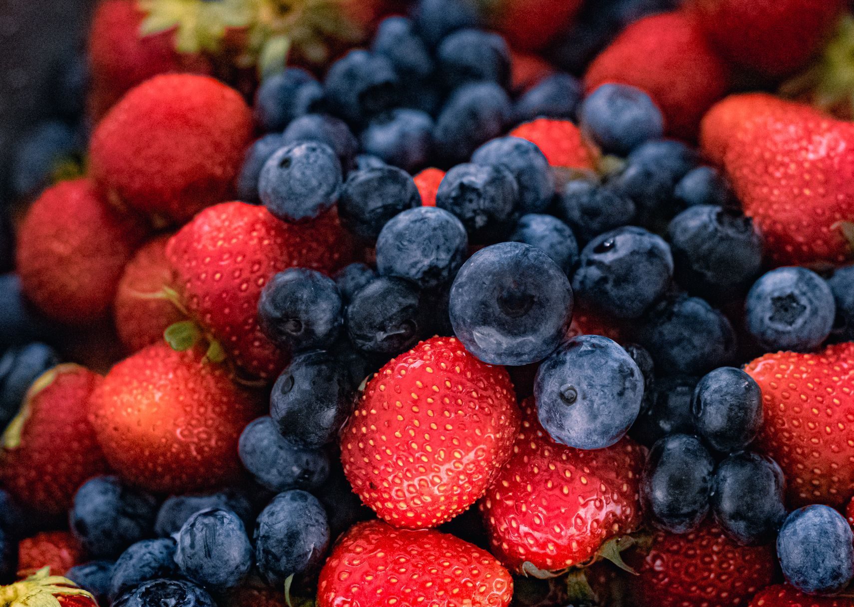 close up shot of strawberries and blueberries